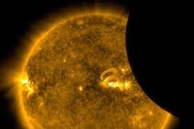 Coronagraph view of the Sun: an occulting disk on the right blocks the sun, revealing the orange solar corona and a coronal mass ejection reaching outward.
